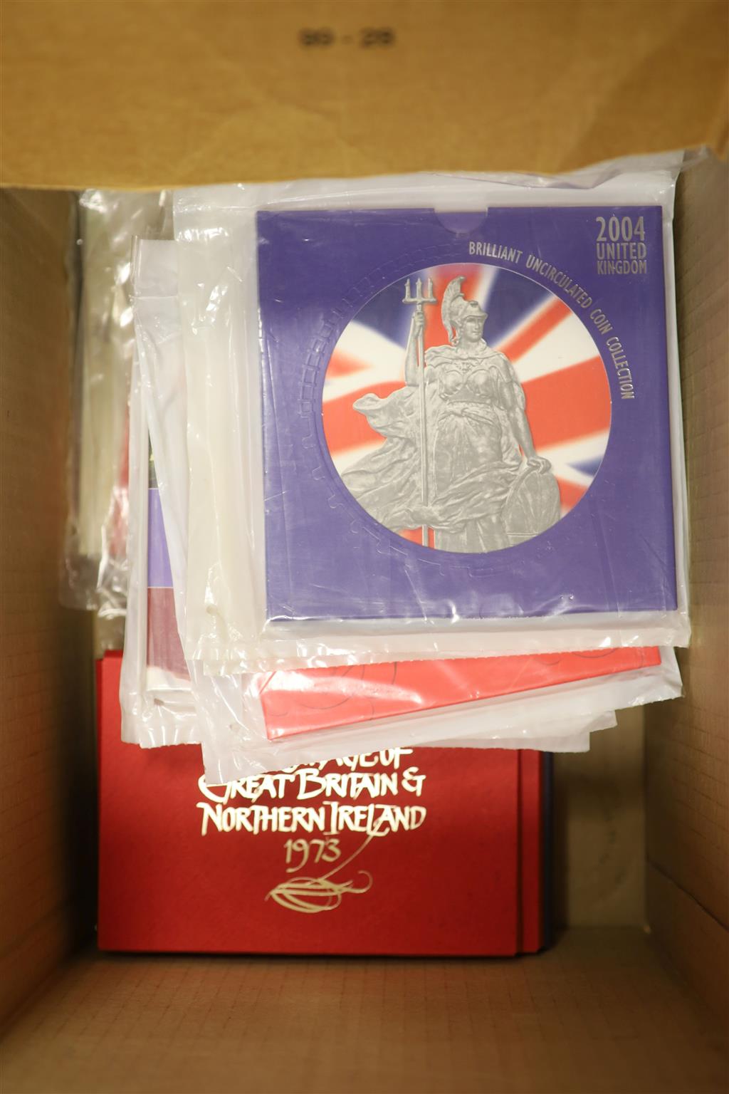 A collection of 45 UK brilliant uncirculated coin year sets, some duplicates and 2 HRH Prince of Wales UNC £5